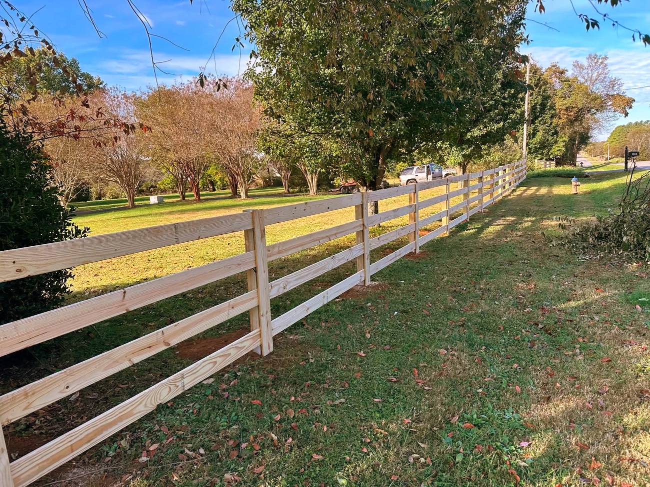 Four rail farm style wood fence
