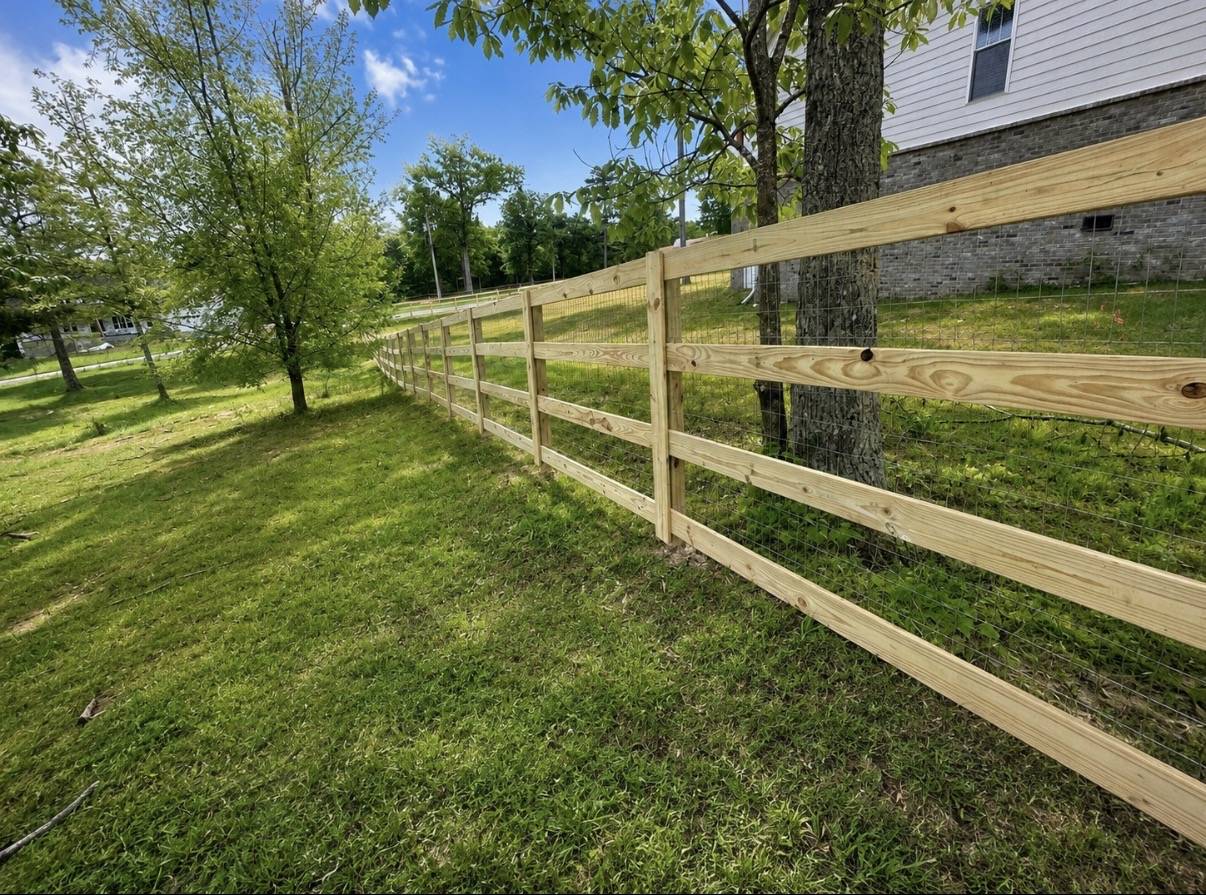 Wood rail fence with wire mesh